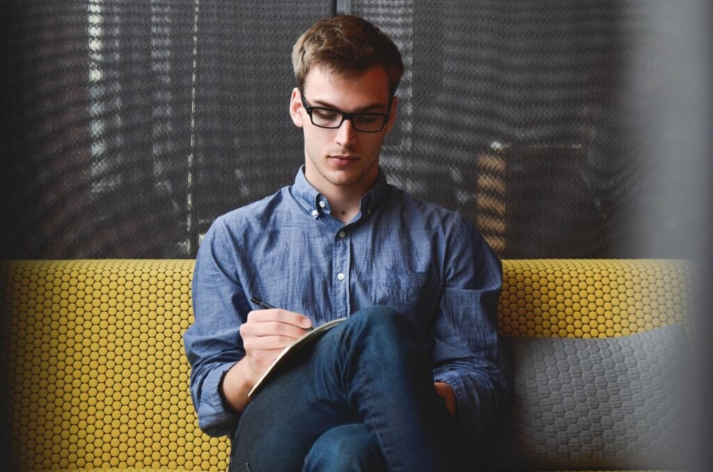 Man writing plans at a desk